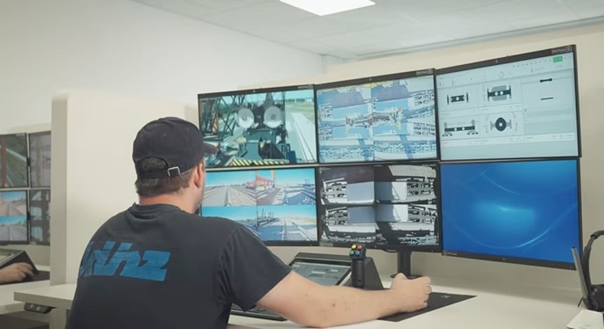 An operator remote-controlling a crane from an office